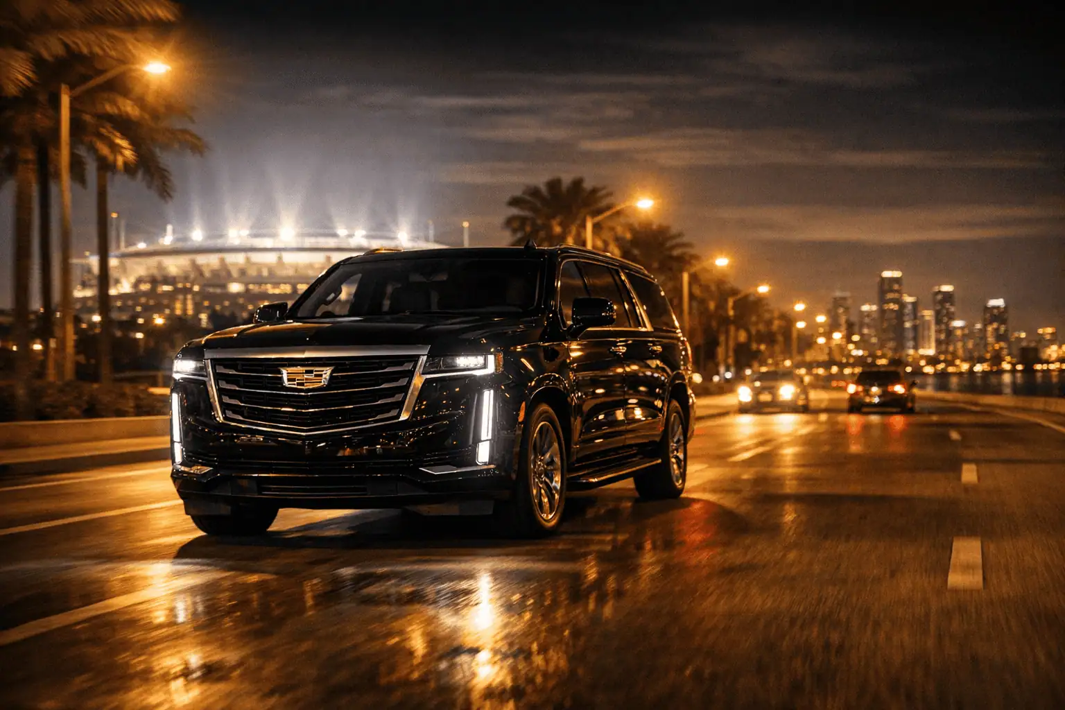 Cadillac Escalade luxury SUV driving at night toward Hard Rock Stadium in Miami — fixed rate World Cup limo service